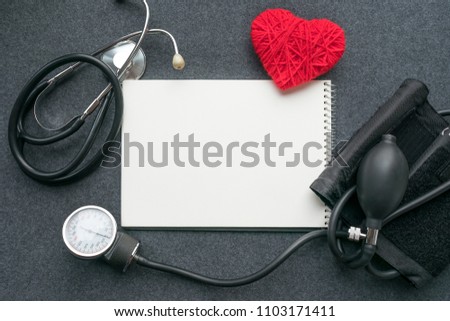 Low carb, low carb high fat (LCHF), Keto, ketogenic diet mockup with white notebook, red thread heart with tonometer on grey table. Benefits, What Eat, How to Reach Ketosis, Optimal Macros