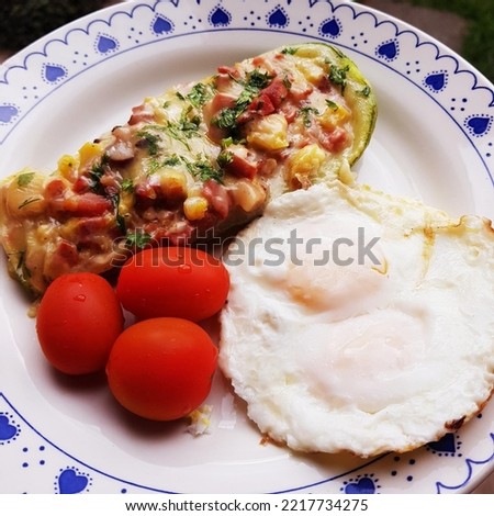 Low carbohydrate meal with fried eggs, Zucchini Boat and tomatoes for healthy life. Paleo food. Lowcarb meal.