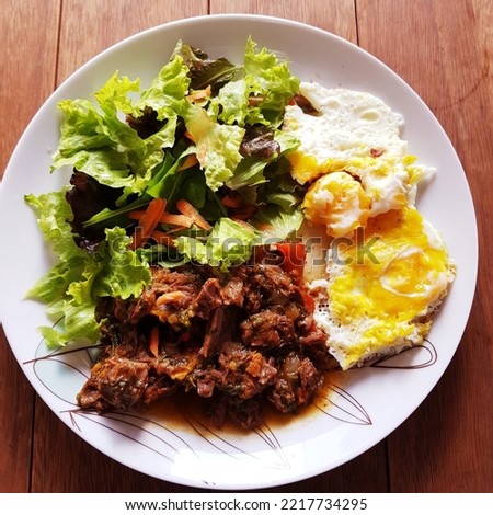 Low carbohydrate meal with fried eggs, tender meat and fresh salad for healthy life. Paleo food. Colorfull lowcarb meal.
