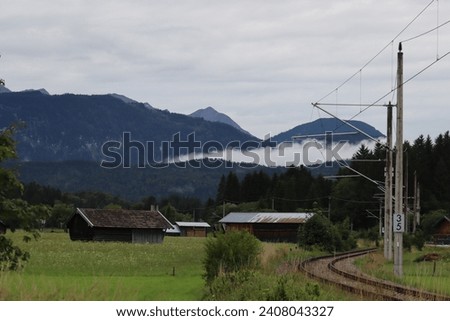 low cloud in mountain ladscape with rails