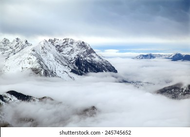 The low clouds over high mountains at winter day