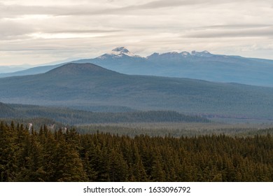 Low clouds over the mountain and pine forest seen from Crater Lake, Oregon, USA