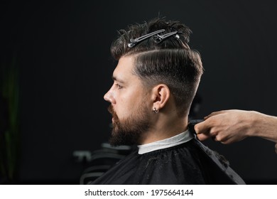 Low Fade Machine Haircut For Handsome Bearded Man In Barbershop. Hair Cut With A Smooth Transition