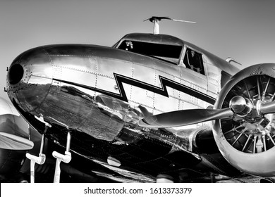 Low, Front-quarter View Of A Gleaming, Silver, Vintage, Lockheed Electra From The Golden Age Of Aviation.