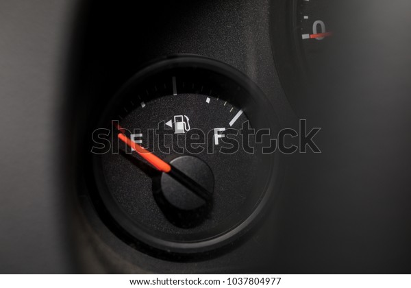 Low fuel guage\
shown in a car shot close\
up