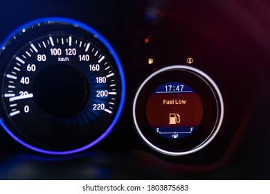 Low Fuel Indicator Light On The Dashboard. Low Fuel Guage Shown In A Car Shot