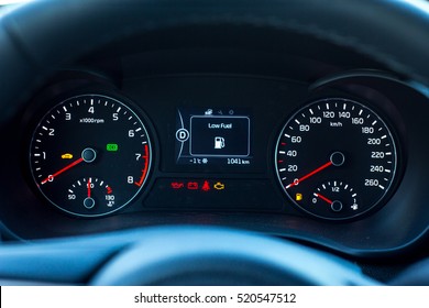Low Fuel sign and additional instruments on car dashboard. - Powered by Shutterstock - Get 15% off with code: PIKWIZARD15