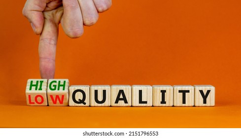Low or high quality symbol. Businessman turns cubes and changes words low quality to high quality. Beautiful orange table orange background. Business low or high quality concept, copy space.