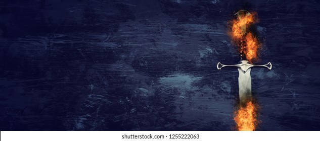 low key banner of silver sword in the flames of fire. fantasy medieval period