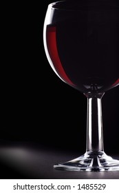 Low Key Glass Of Red Wine With Specular Highlights