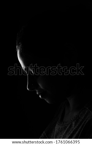 low key image of a beautiful Asian/ Indian woman in monochrome