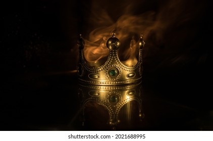 low key image of beautiful kings crown over wooden table. vintage filtered. fantasy medieval period. Selective focus. Colorful backlight - Shutterstock ID 2021688995