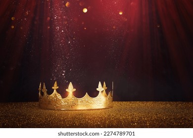 low key image of beautiful queen or king crown over glitter table. fantasy medieval period
