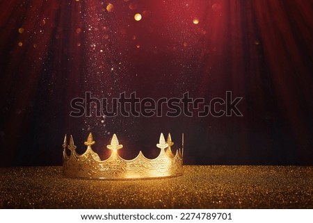 low key image of beautiful queen or king crown over glitter table. fantasy medieval period