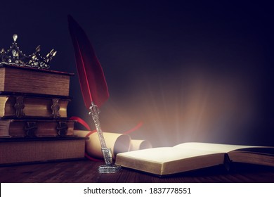 low key image of beautiful queen/king crown, old books and feather quill ink pen over wooden table. fantasy medieval period - Powered by Shutterstock