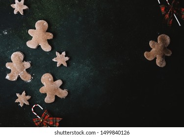 Low Key Image Of Gingerbread Man Cookies, Top Down View With Copy Space For Christmas Holiday.