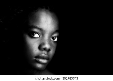 low key lighting photo portrait of a black american female black girl sad face close up teenage teenager. black woman portraying emotion of sadness , upset, sad, depression, neglected and grief. 