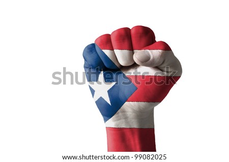 Low key picture of a fist painted in colors of puertorico flag