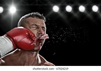 low key portrait of boxer getting knocked out - Powered by Shutterstock