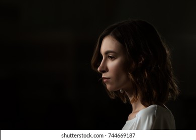 Low Key Portrait Of Pretty Girl In Profile