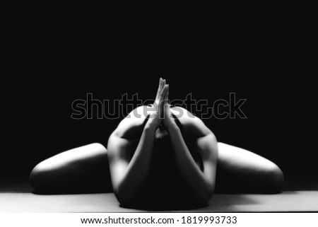 Low key portrait, rimlight portrait woman yoga on black background
