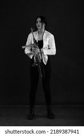 Low Key Portrait Of Woman With Machine Gun