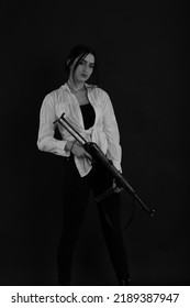 Low Key Portrait Of Woman With Machine Gun