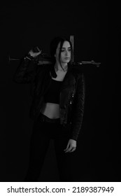 Low Key Portrait Of Woman With Machine Gun