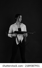 Low Key Portrait Of Woman With Machine Gun