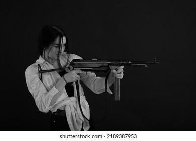 Low Key Portrait Of Woman With Machine Gun