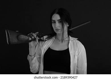 Low Key Portrait Of A Woman With Vintage Shotgun