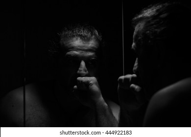 sad man looking in the mirror