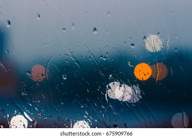 Low key romantic and lonesome mood near glass window in raining day background