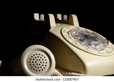 A Low Key Shot Of A Rotary Phone On Hold.