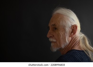 Low Key Studio  Portrait Of Beautiful Old Man - Rocker Fan - Looking Over His Shoulder At The Camera. Horizontally.