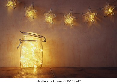 low key and vintage filtered image of fairy lights in mason jar with. selective focus
 - Powered by Shutterstock