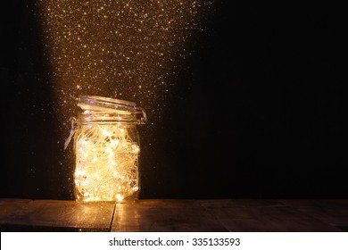 low key and vintage filtered image of fairy lights in mason jar with. selective focus. glitter overlay
 - Powered by Shutterstock