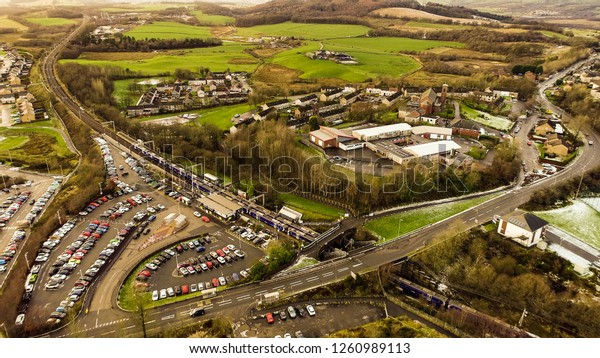 Low level aerial image over Croy railway\
station on the Glasgow to Edinburgh\
line.