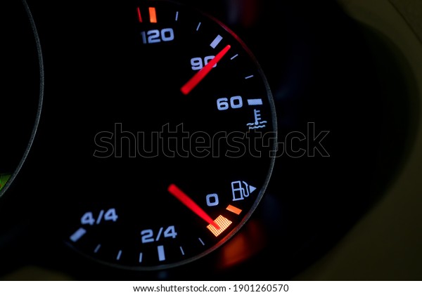 Low Level fuel warning light in car dashboard. Empty\
fuel warning light in car dashboard. Fuel pump icon. gasoline gauge\
dash board in car with digital warning sign of run out of fuel turn\
on. 