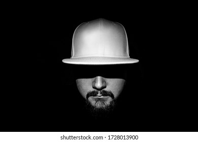 Low Light Monochrome Portrait Of A Man With A White Cap