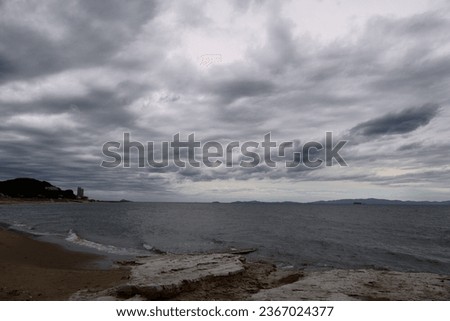 Low, overcast clouds and rough seas, the sea before a storm