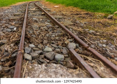 Low Perspective Image Of Narrow Guage Railroad Tracks For A Children's Train In Agnew Park, Stranraer, Scotland, United Kingdom