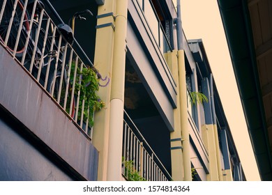 Low Perspective Looking Up To A Hotel's Balconies With A Bicycle Resting On The Balustrade