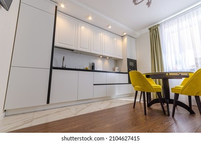 Low Perspective On A White Illuminated Kitchen