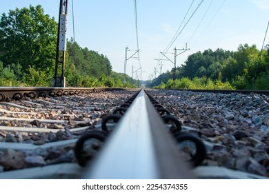 Low perspective railroad track with catenary visible - Shutterstock ID 2254374355