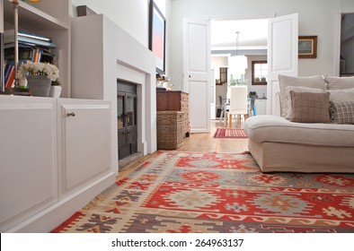 Low Perspective Still Life Of Interior Design Home Living Room With A Comfortable White Sofa With Cushions, And Quality Carpets, Interior. Aspirational Relaxing Home Family Room, Indoors Lifestyle.