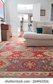 Low Perspective Still Life Of Interior Design Home Living Room With A White Sofa With Cushions, And Quality Carpets, Home Interior. Aspirational And Relaxing Home Family Room, Indoors Lifestyle.