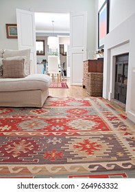 Low Perspective Still Life Of Interior Design Home Living Room With A Comfortable White Sofa With Cushions And Quality Carpets, Interior. Aspirational And Relaxing Home Family Room, Indoors Lifestyle.