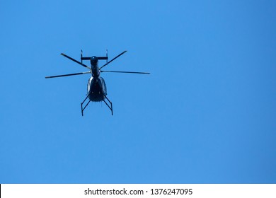 Low POV View Of Underside Of Helicopter In The Sky