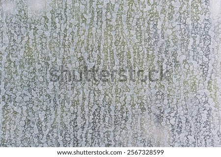 A low resolution, pixelated image with an abstract pattern in muted colors gray, white, green, blue, a